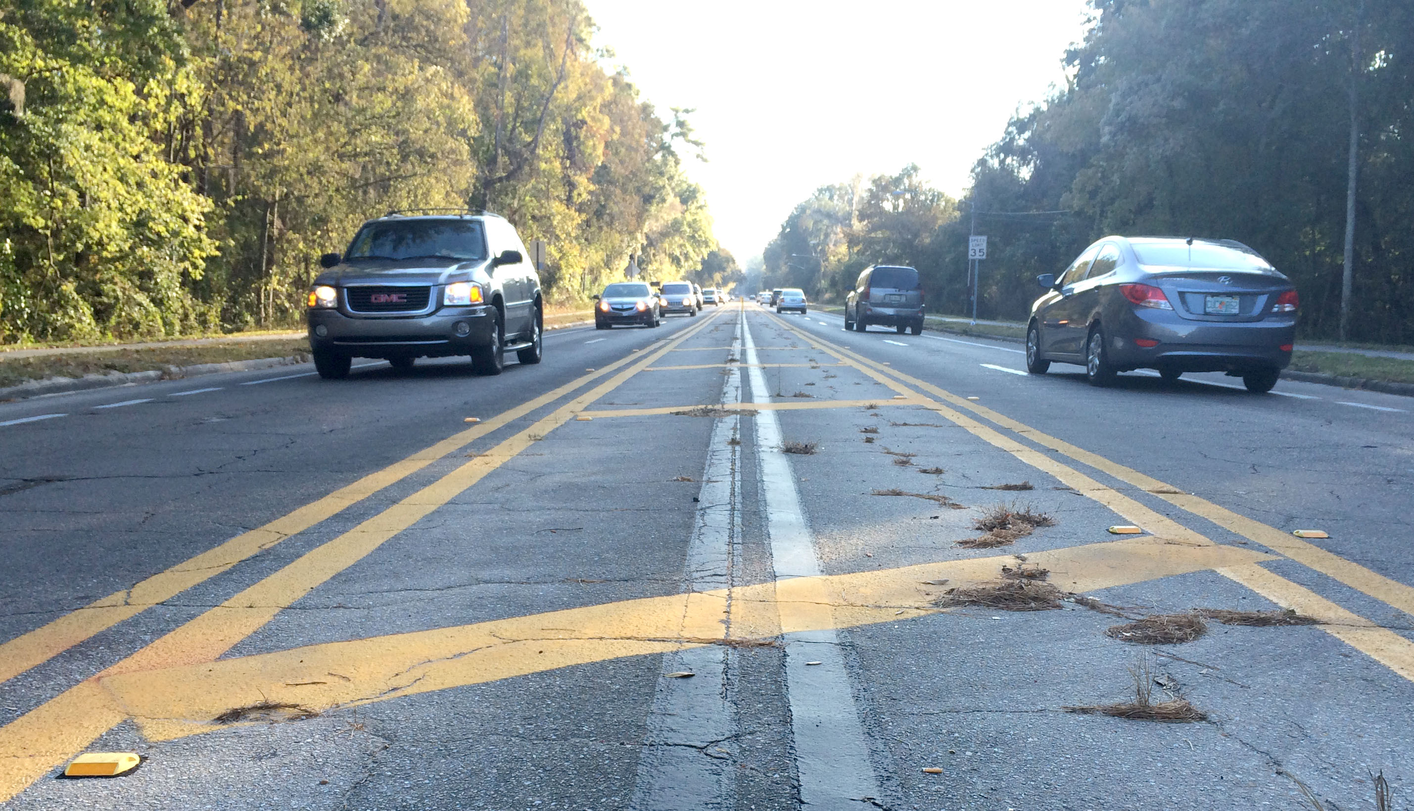 Cars travel through the two-lane trial section of NW 8th Avenue just east of NW 34th Street in Gainesville on November 21st. The blacked-out lines from the previous setup are still visible.